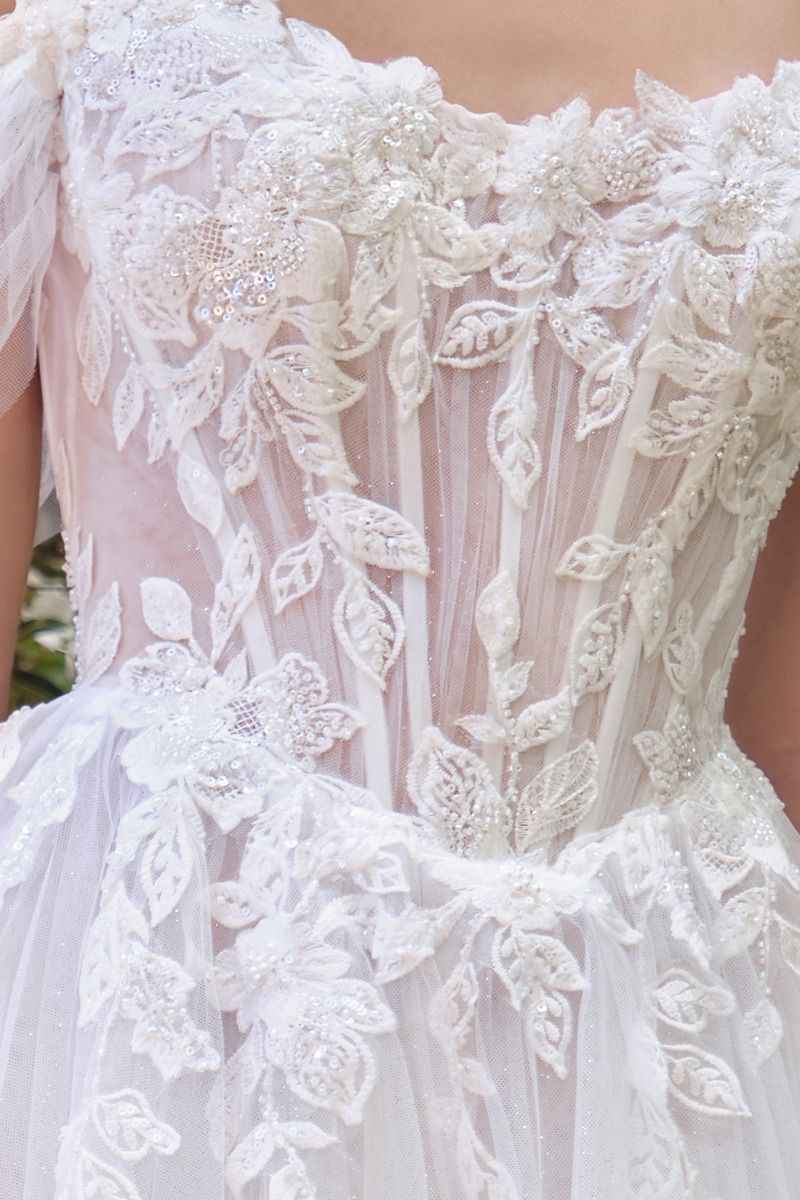 Off-the-shoulder illusion neckline with floral appliqué
